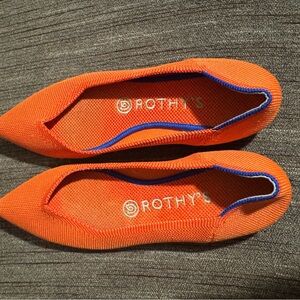 Rothy's The Point flats in the retired Persimmon orange color with a blue trim